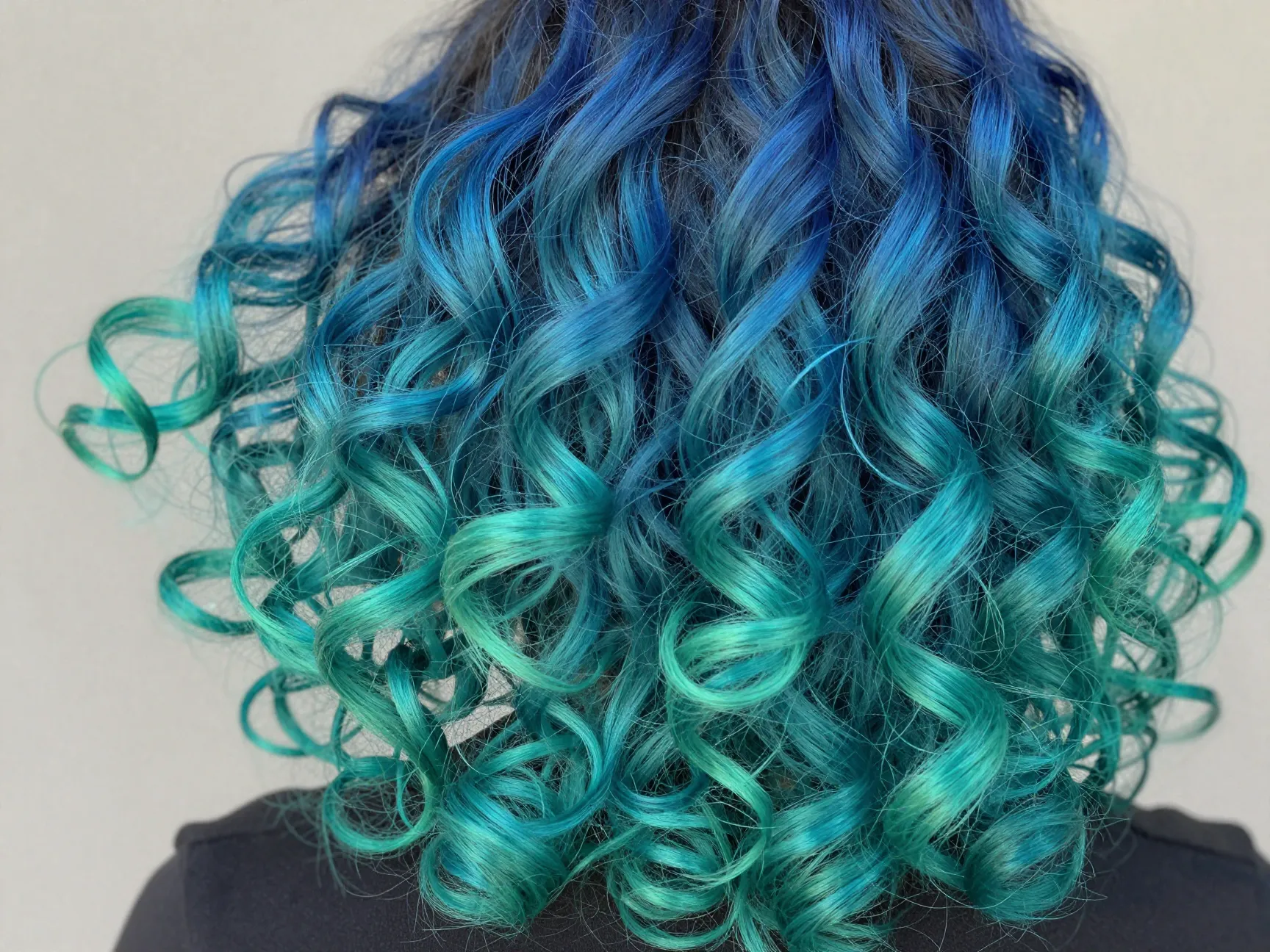 Blue green blend ombre effect within each curly ringlet