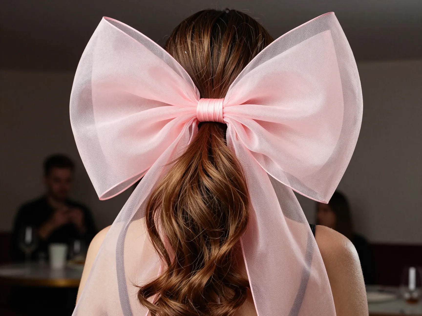 High voluminous ponytail with oversized blush organza bow