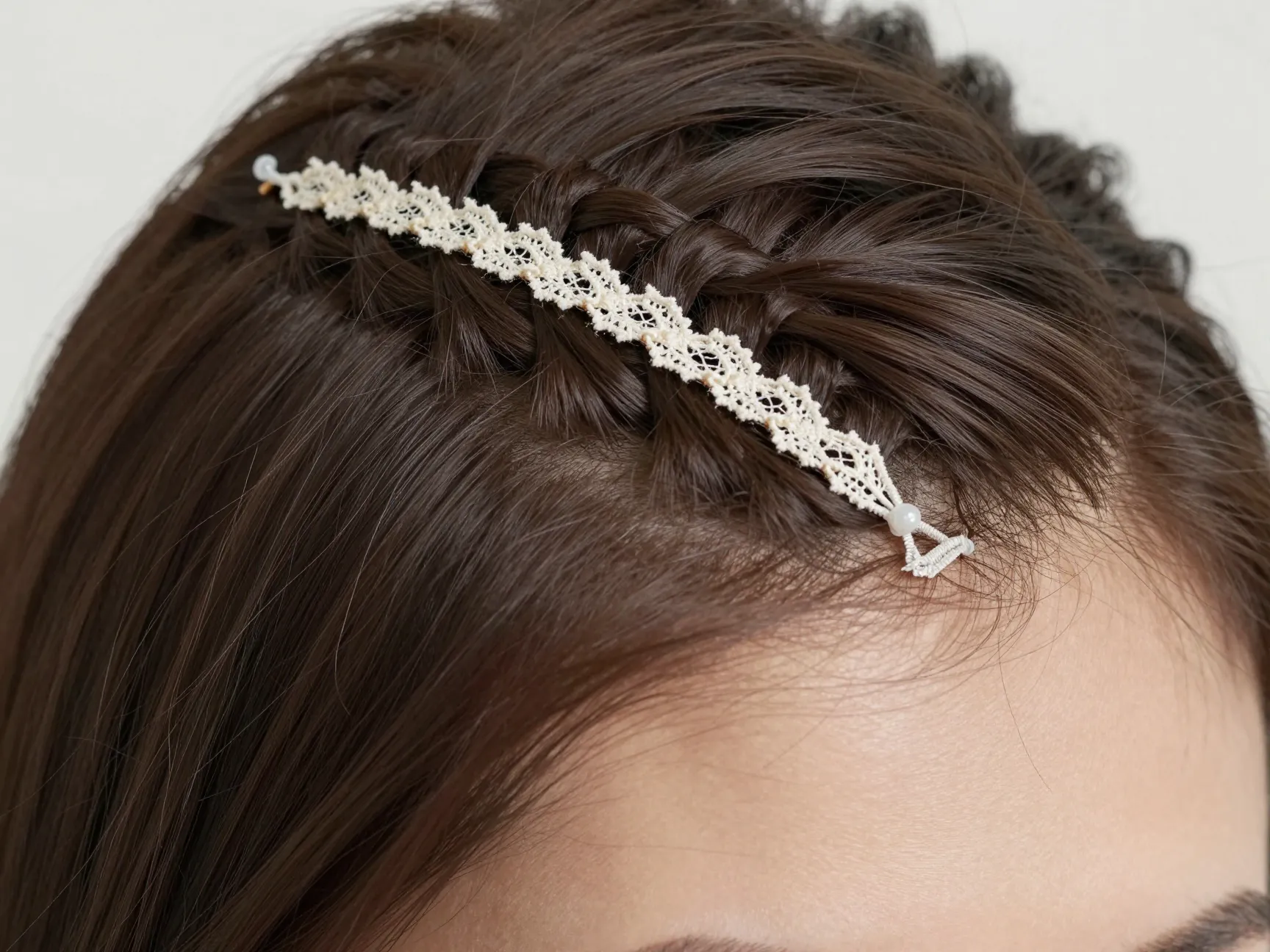 Delicate lace braid part line along the deep side part