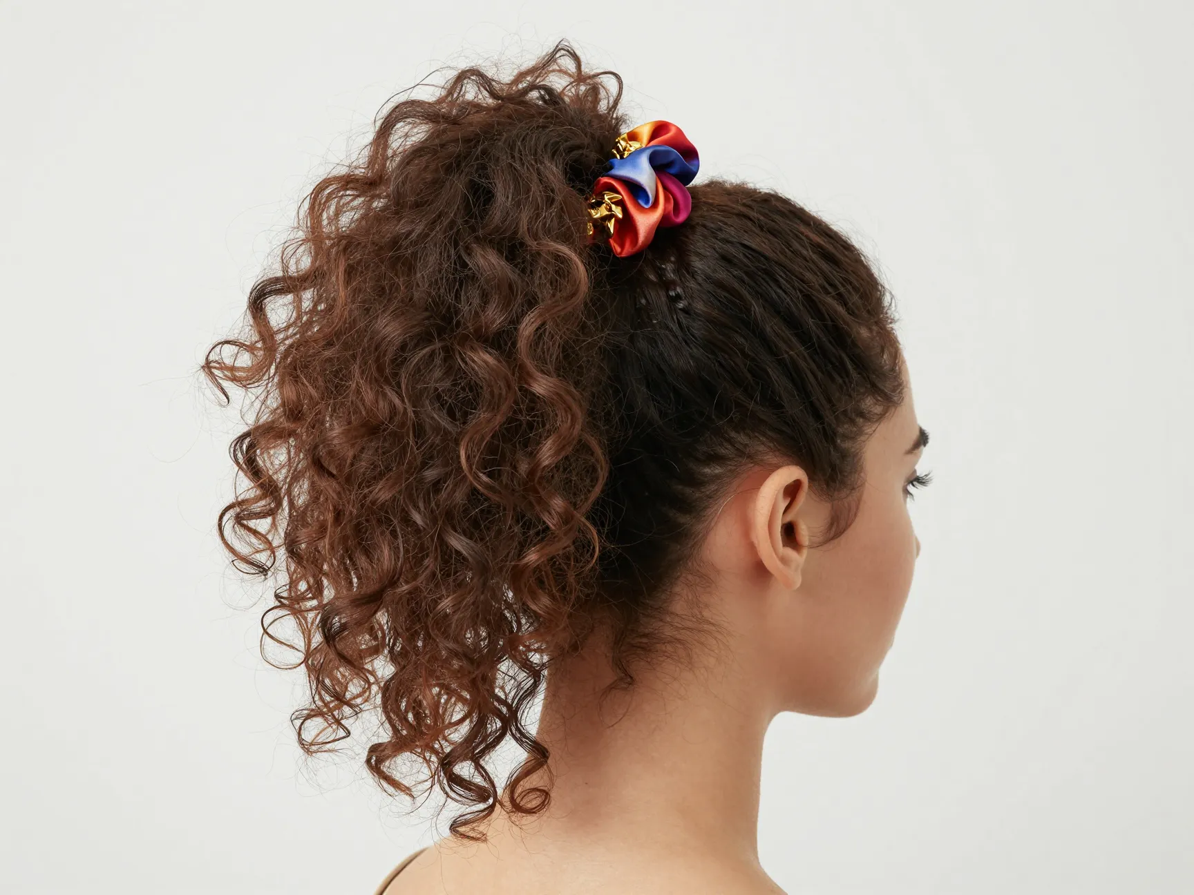 High voluminous curly ponytail with silk scrunchie and gold cuff