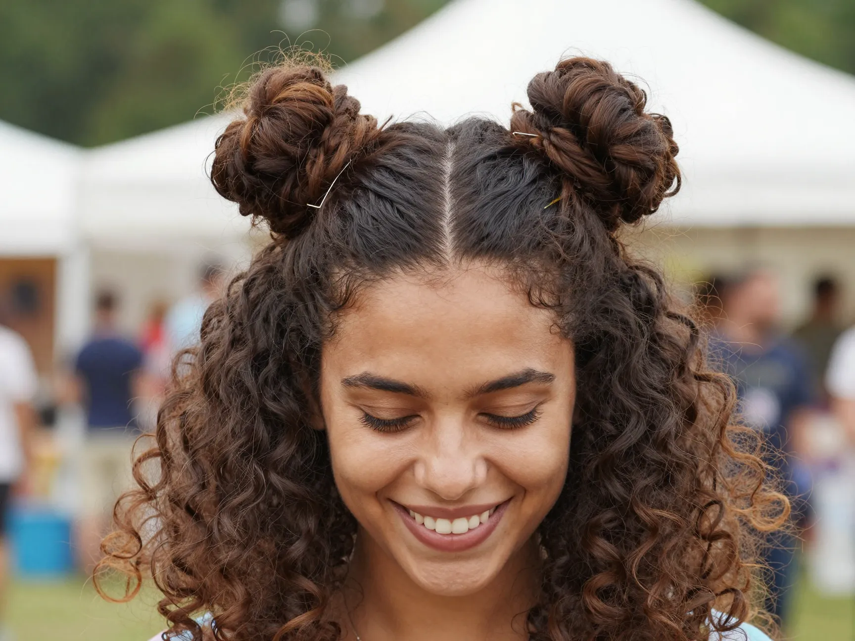 Half up space buns on curly hair with bottom half down