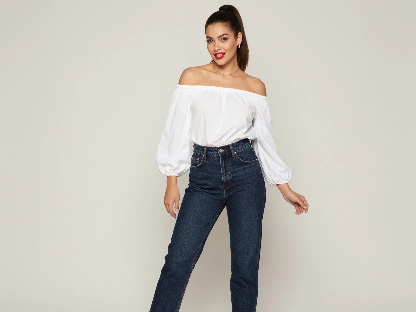 Off shoulder top with high waist jeans and heels