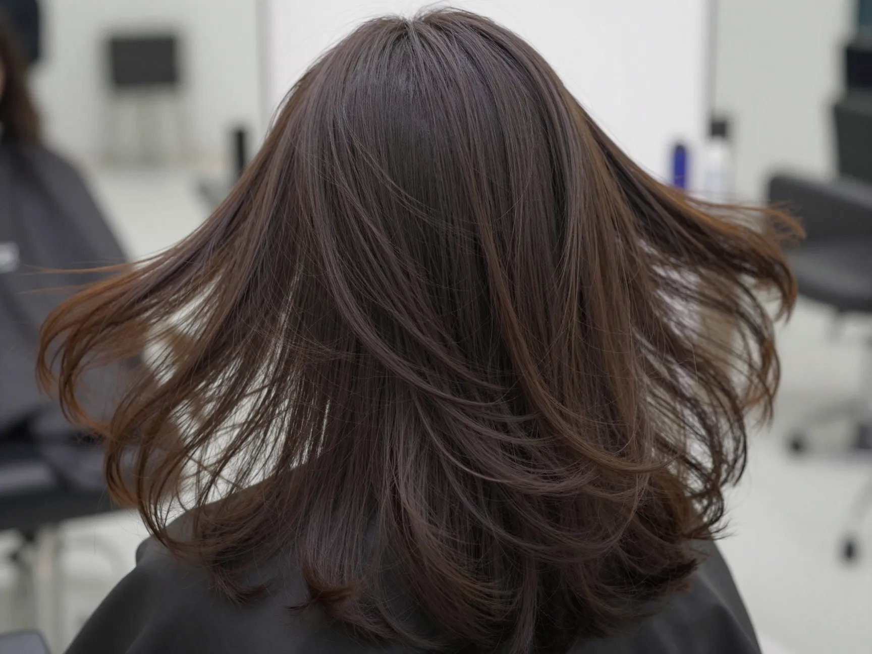 Voluminous butterfly cut for thick hair with thinned light curtain bangs