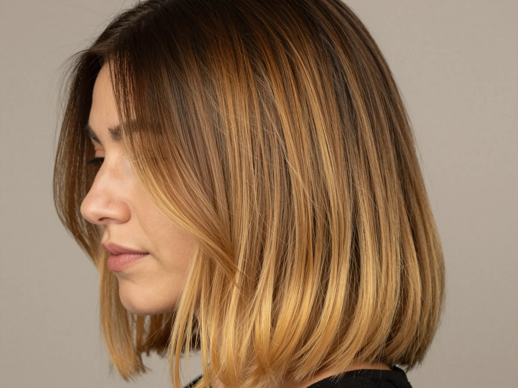 Woman with classic shadow root balayage honey caramel blonde gradient