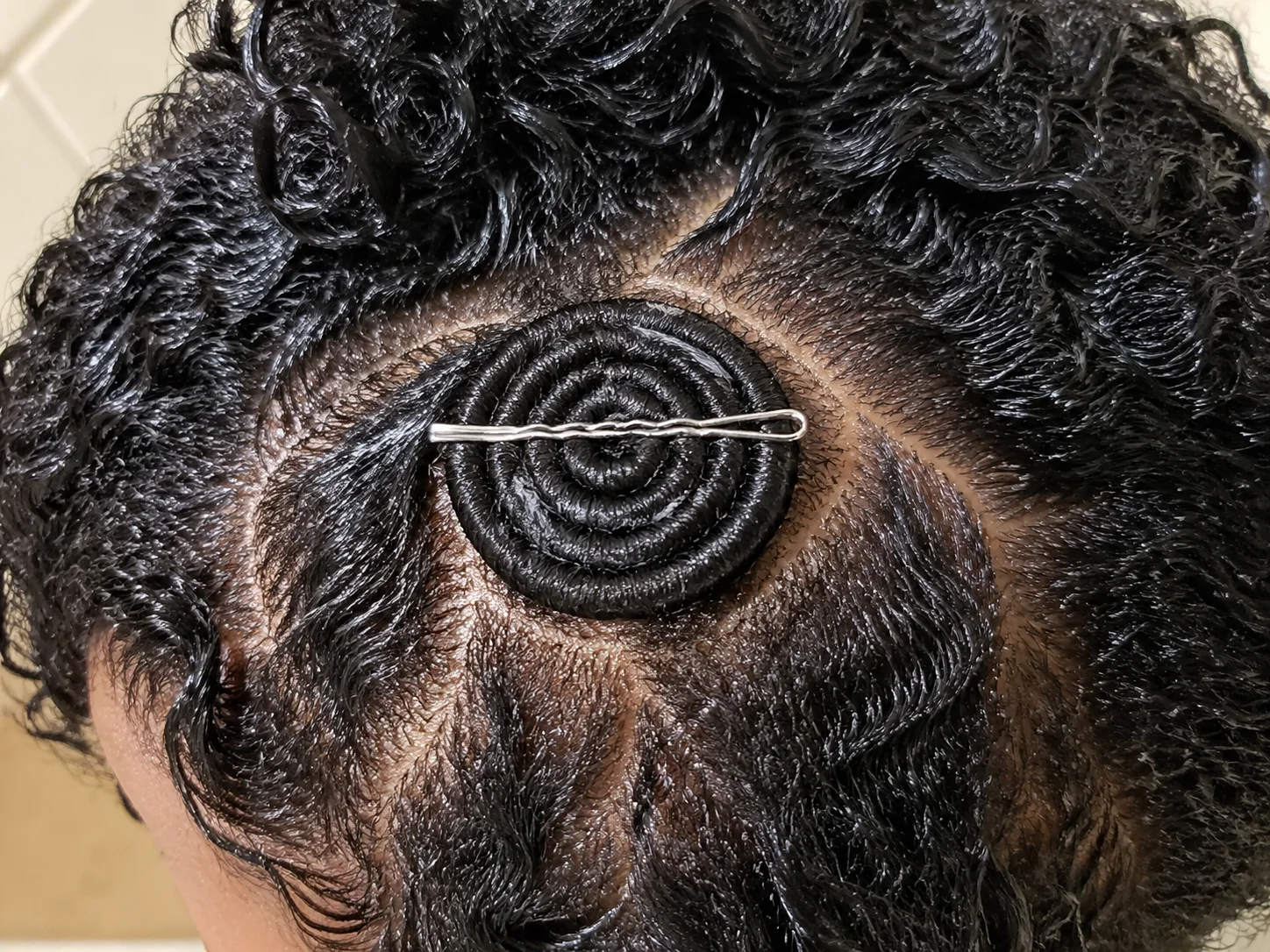 Bobby pinned coil flat against scalp for pin curl reshaping