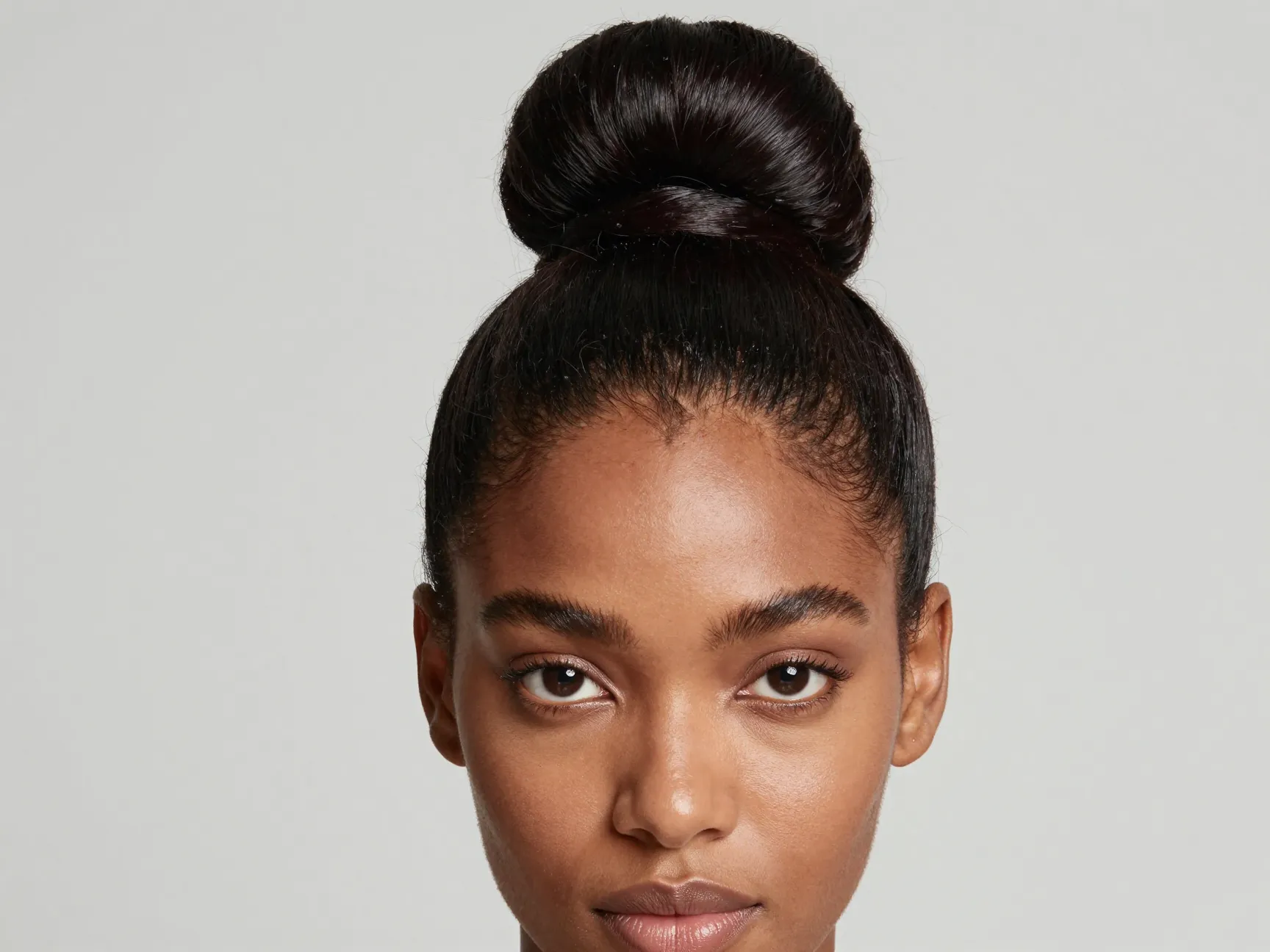 Classic sleek bun with polished edges on a black woman