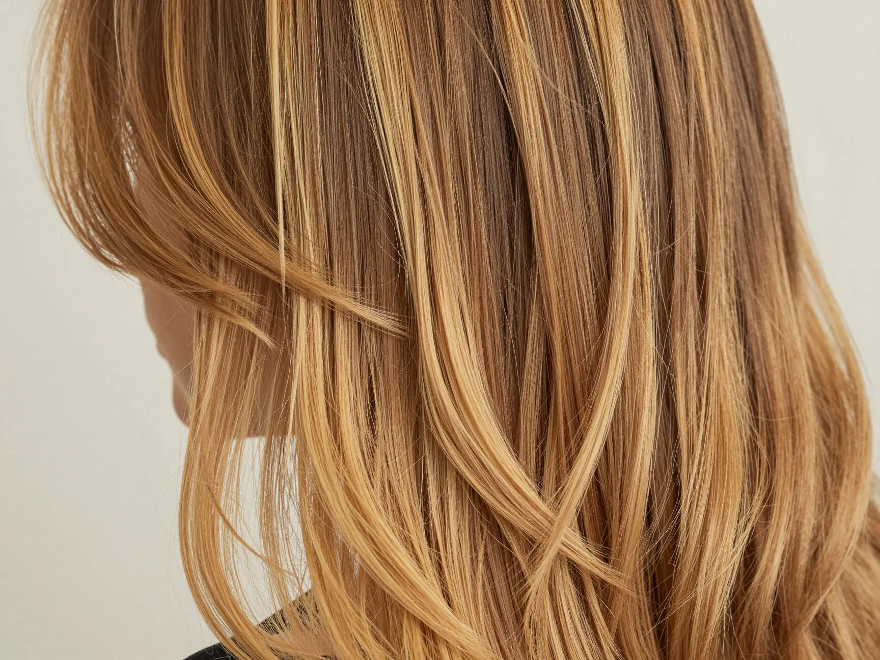 Honey blonde highlights on woman with dark blonde base hair