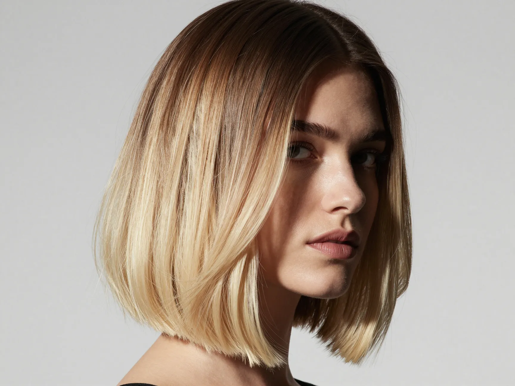 Vanilla balayage with high contrast on woman with mid length bob