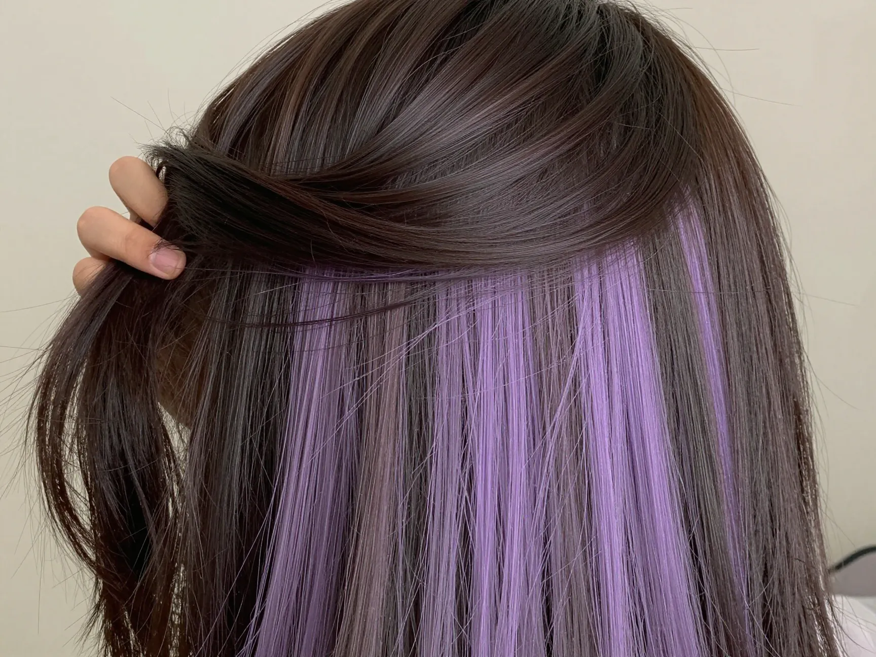 Subtle light purple peekaboo highlights under dark brown hair
