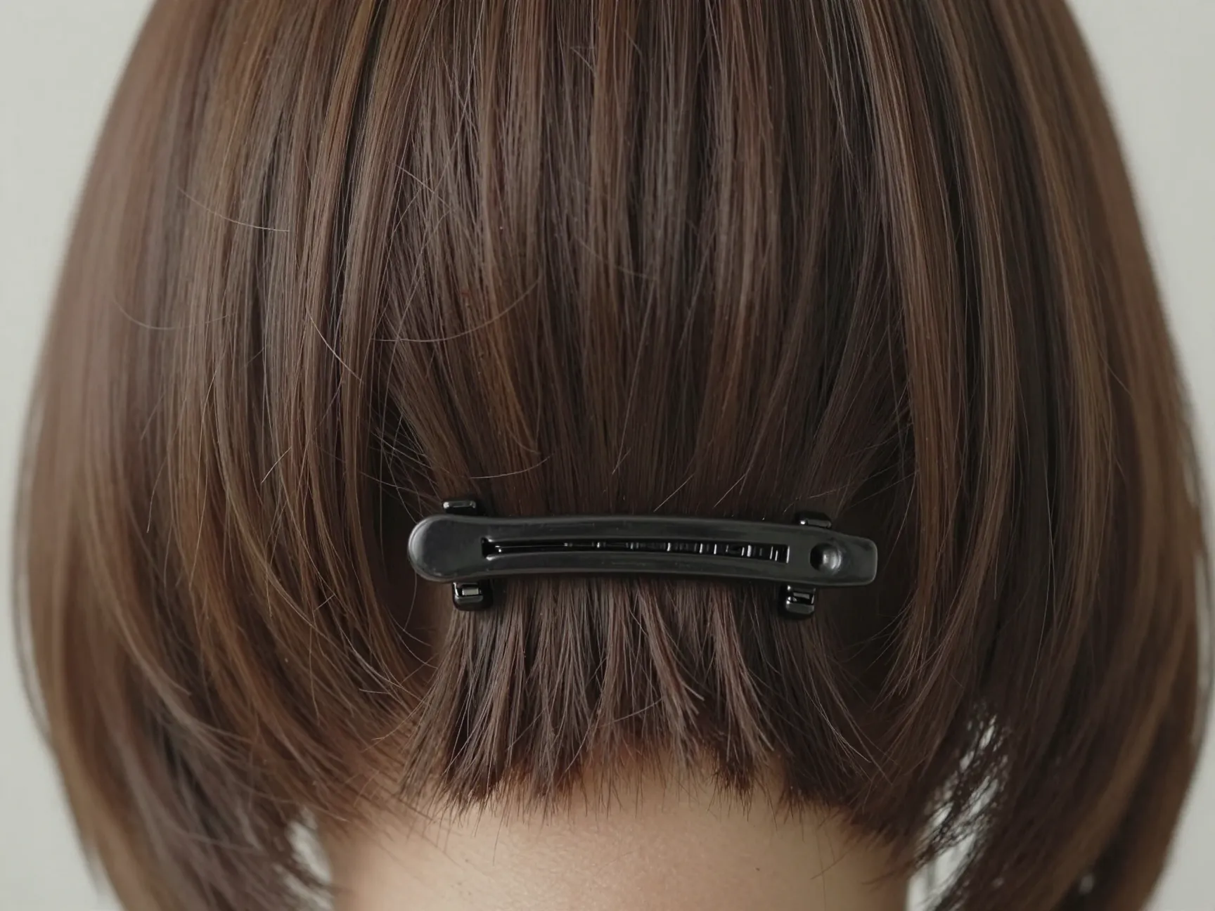 Bottom layer of hair at the nape clipped horizontally and hidden
