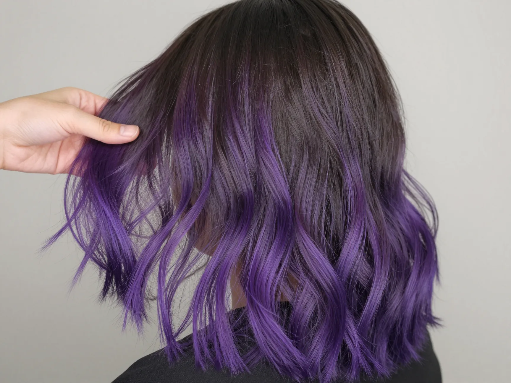 Gradual purple balayage painted on dark roots to vibrant ends