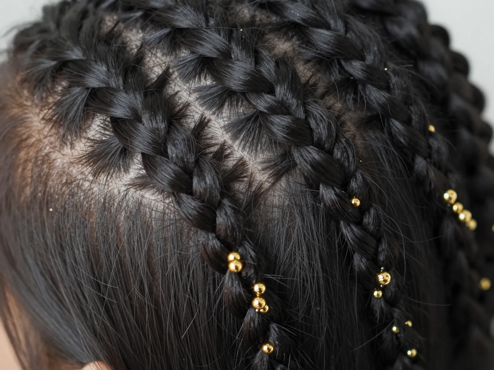 Micro braids with gold seed beads on black hair detail
