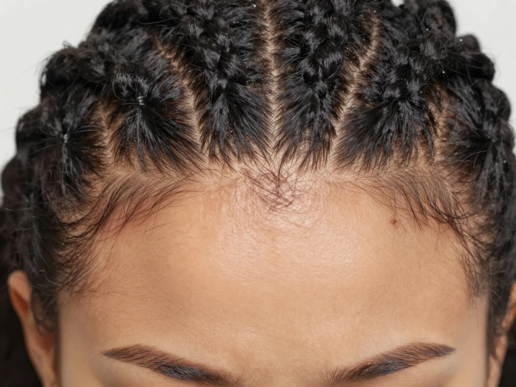 Knotless tiny fulani braids with flat roots close up