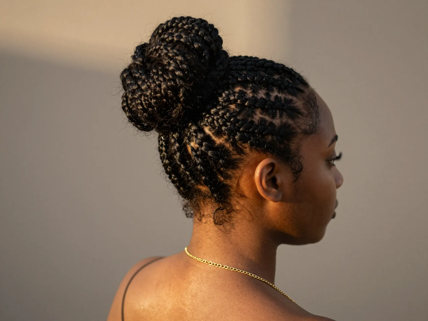 Half up bun with tiny fulani braids and gold chain