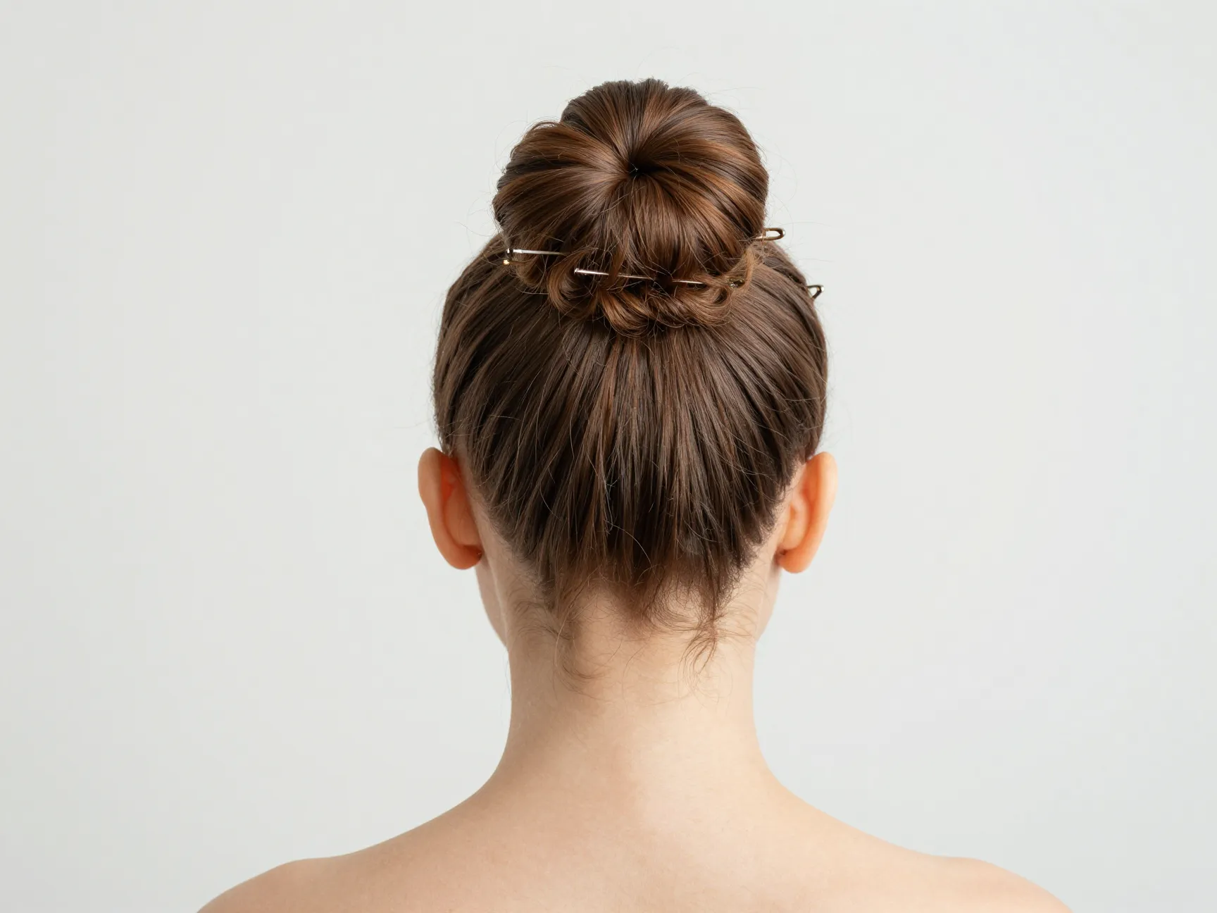 Neat protective top knot bun with bobby pins