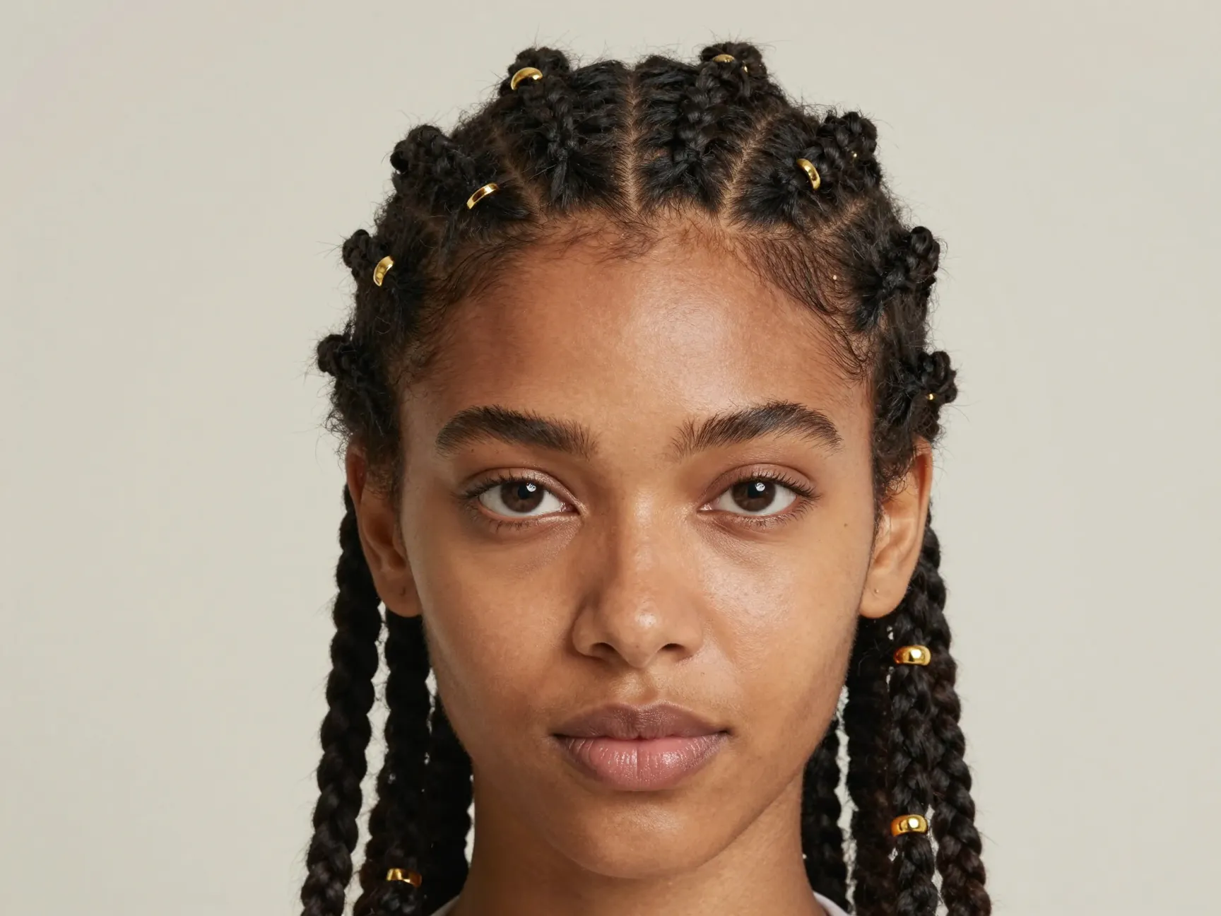 Woman face forward classic cornrows with open gold cuff beads