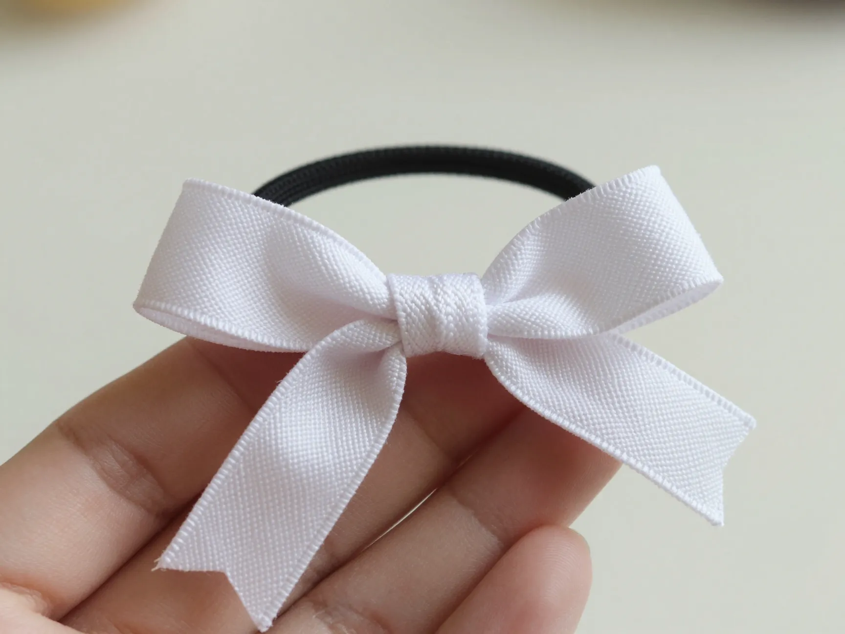 Simple tied ribbon bow on elastic hair tie classic shoelace knot