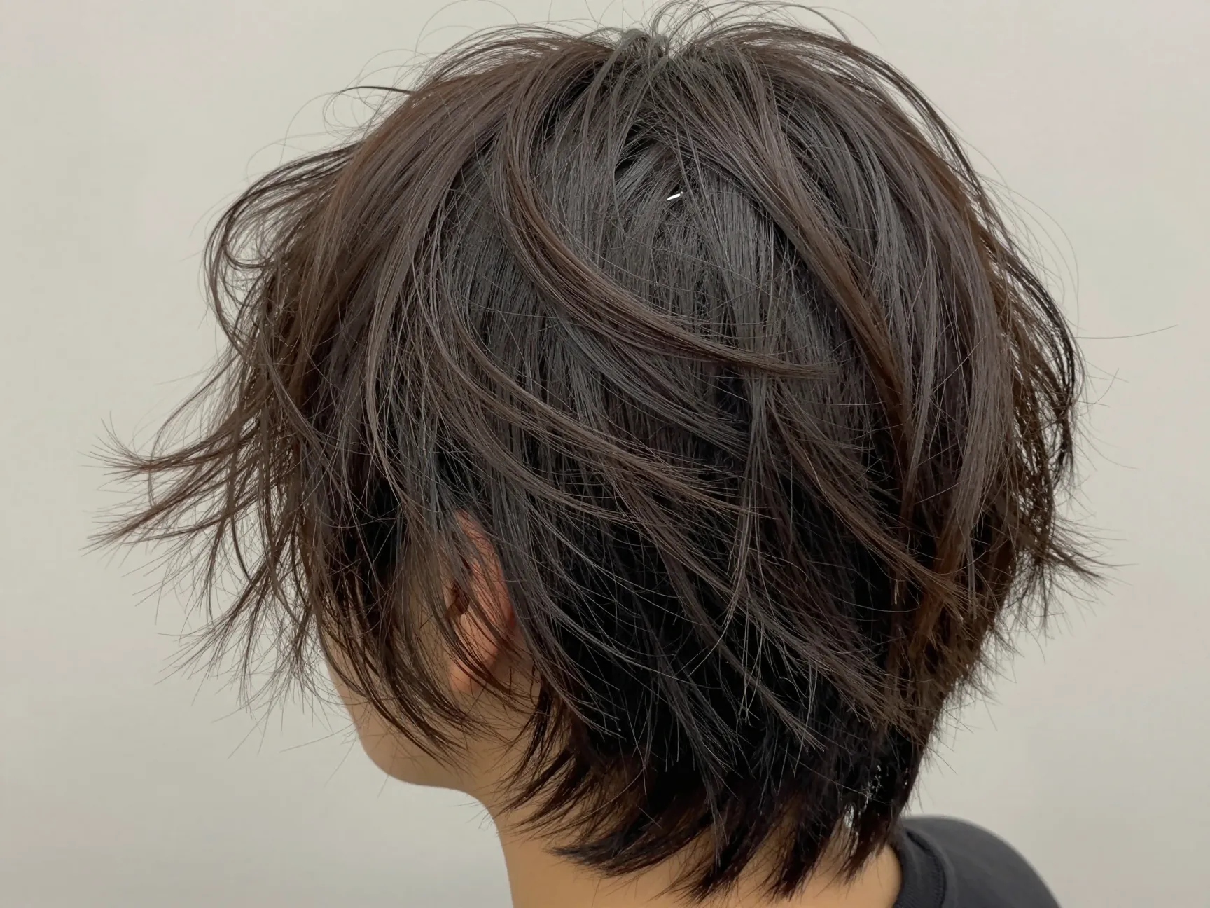Messy slick back hairstyle effortless undone texture short hair