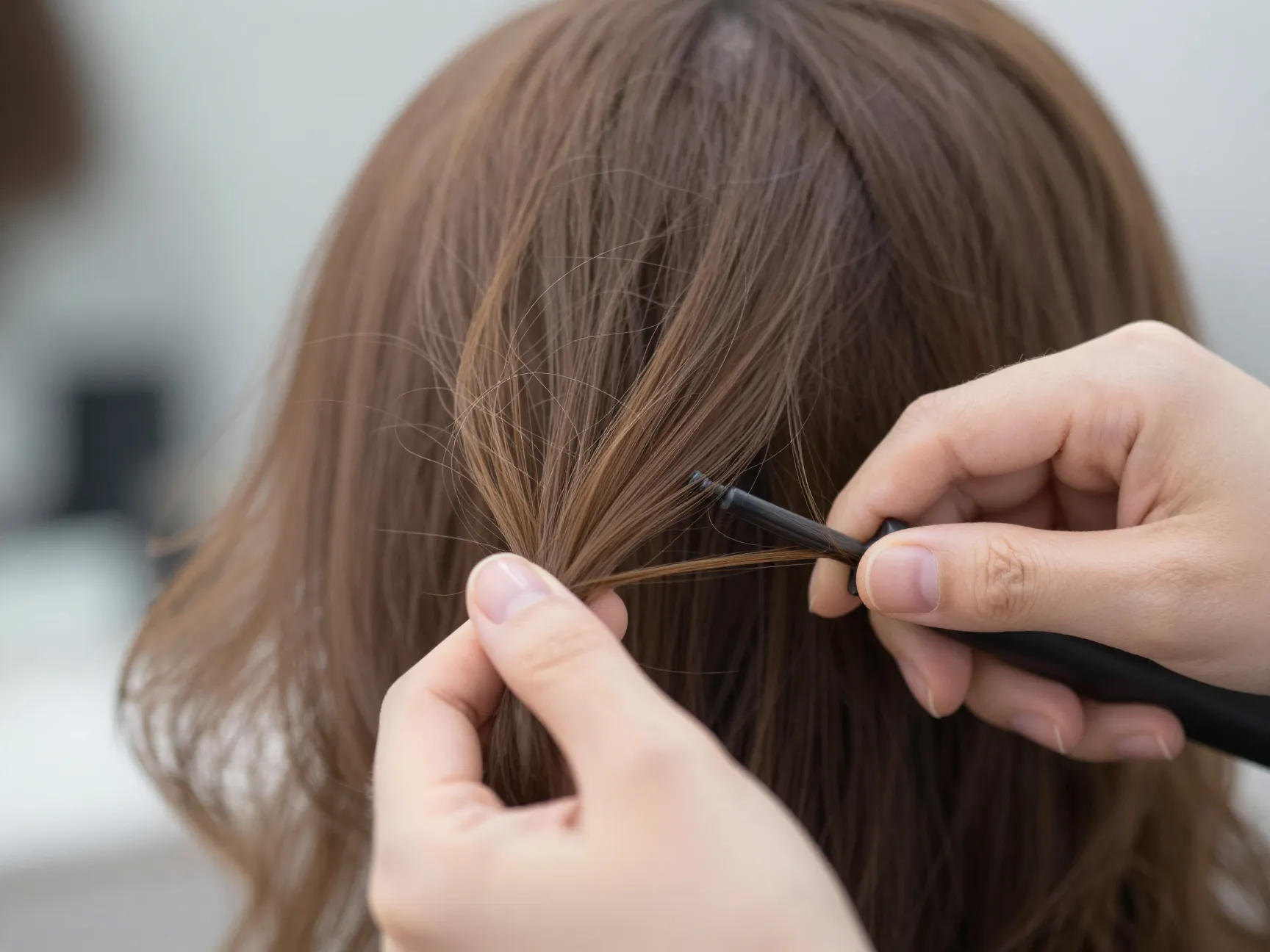 Delicate korean airy tendrils styled with a small barrel curling iron