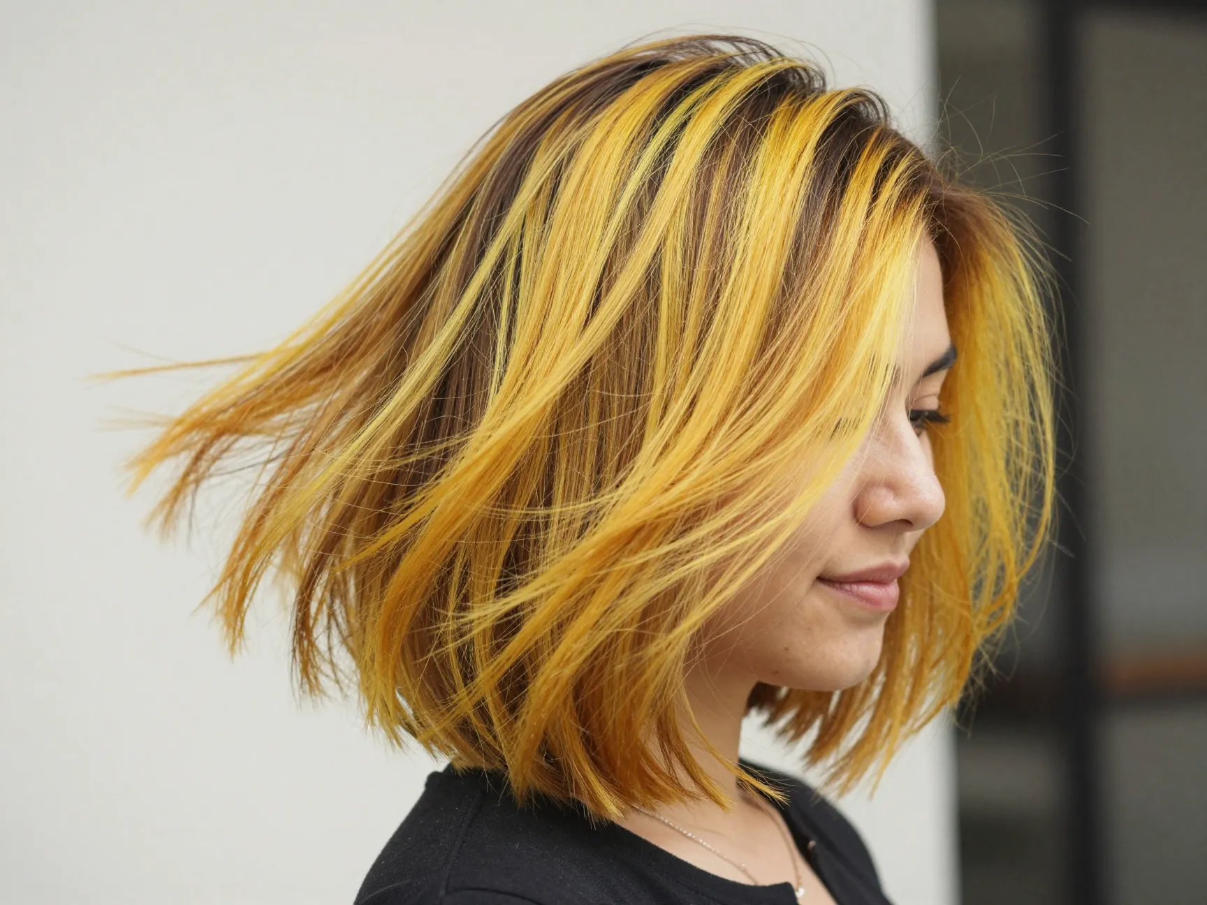 Fun golden yellow streaked textured bob flirty vivacious trend