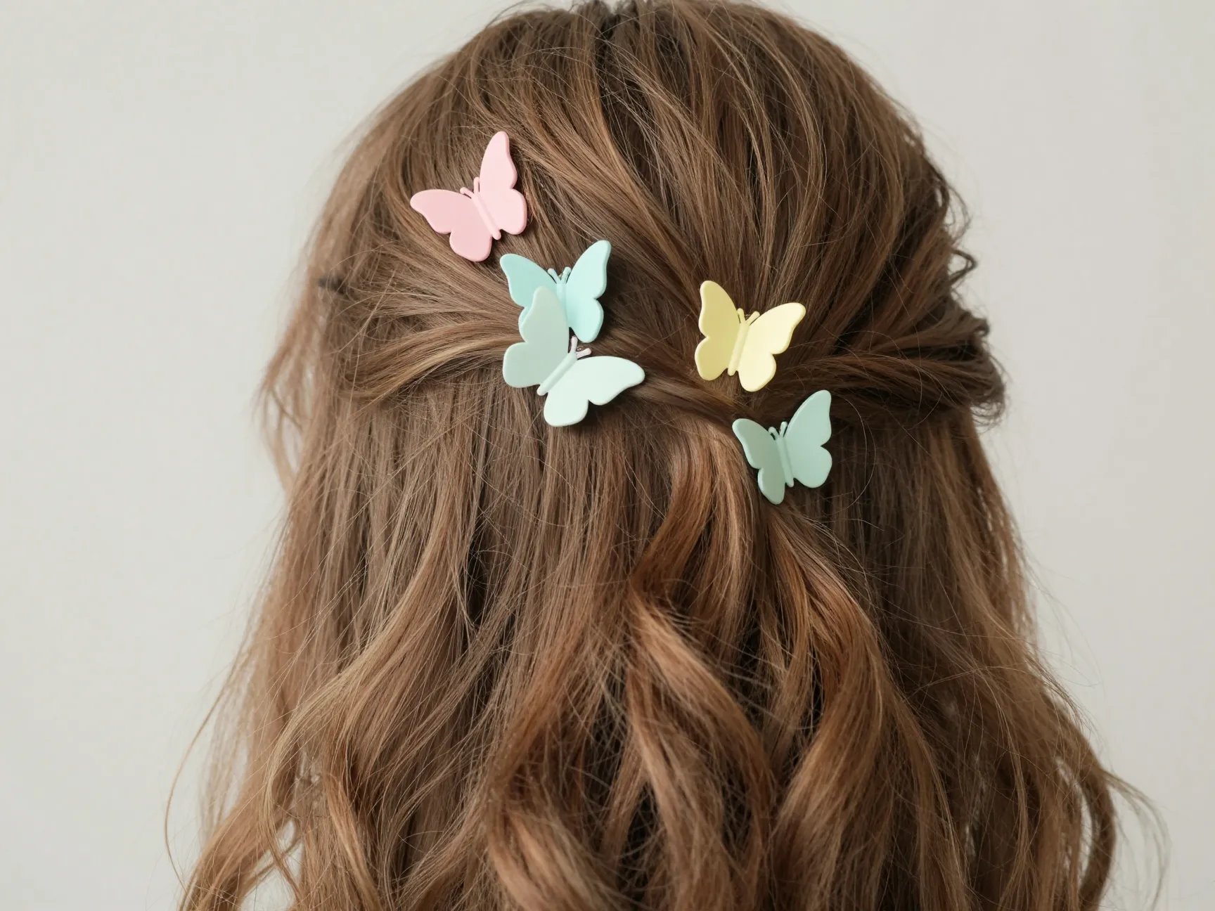 Half up hair with scattered pastel butterfly clips at crown