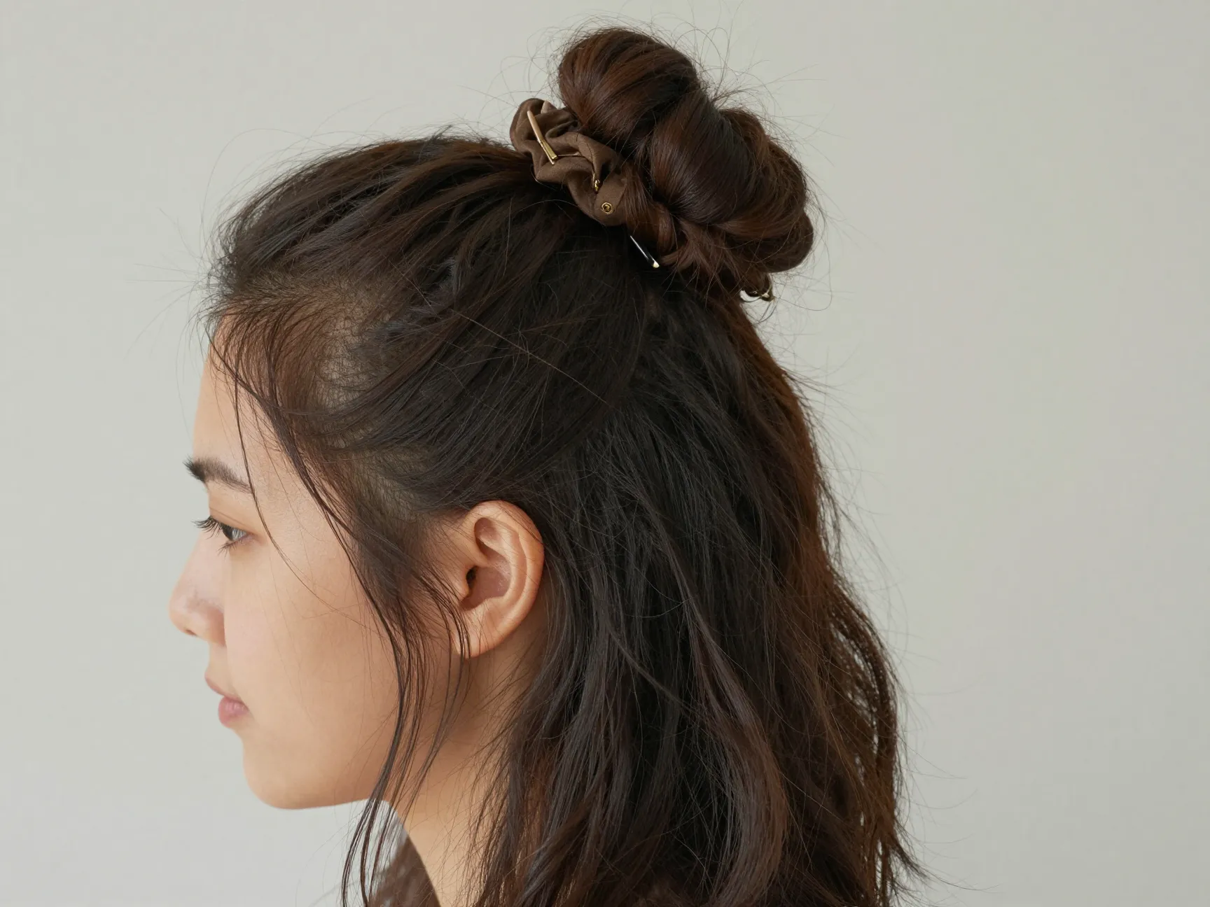 Effortless half up bun with face framing pieces on thick hair