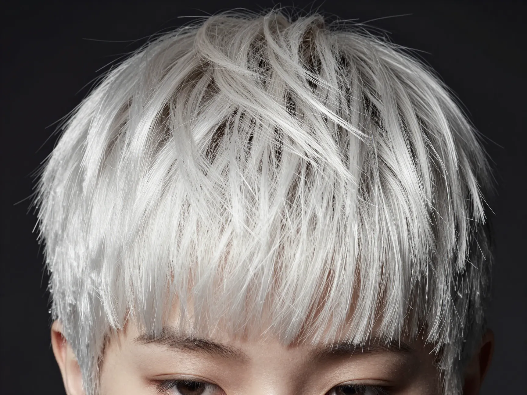 Edgy platinum pixie cut with soft crown root shadow