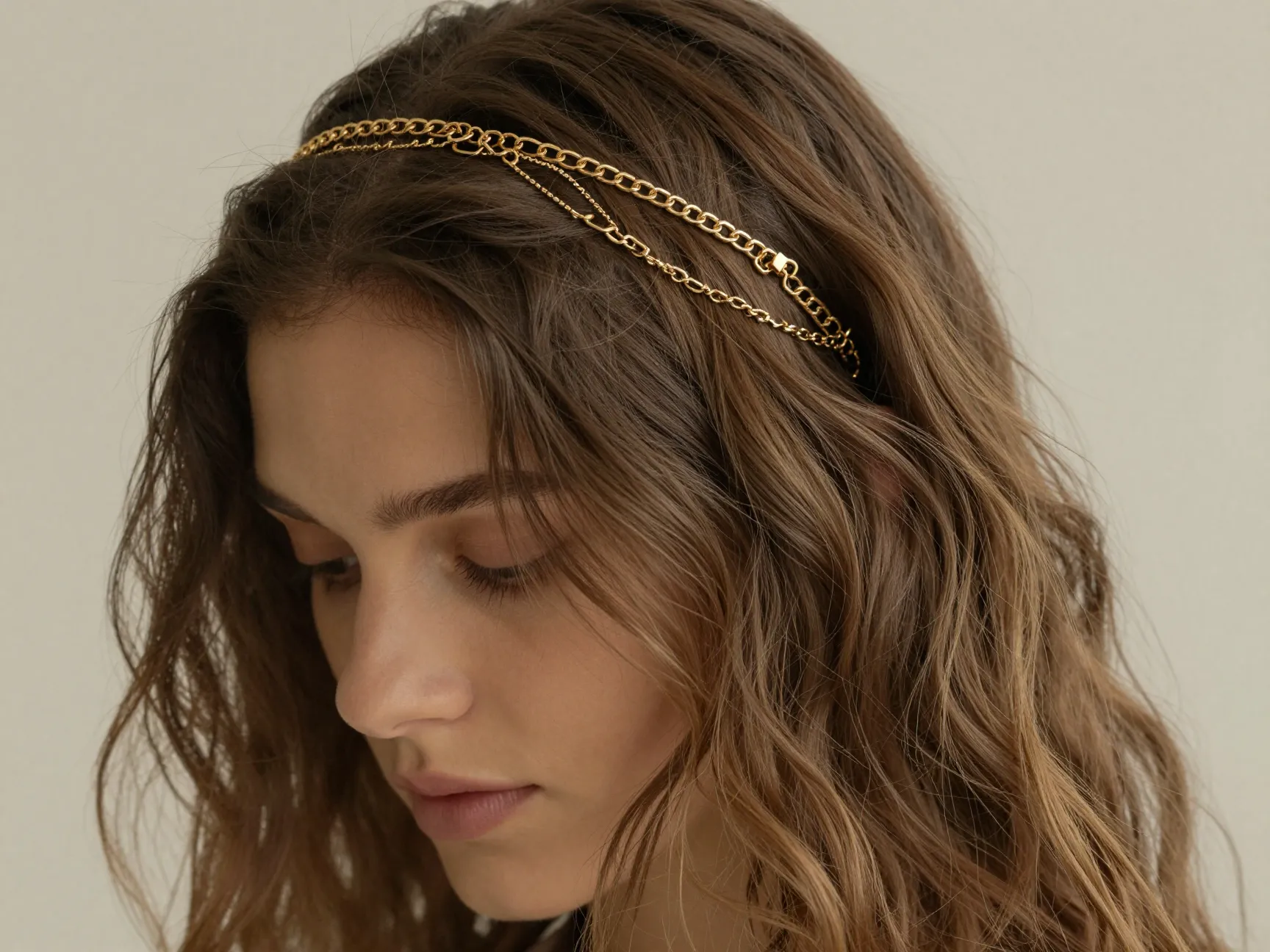 Delicate gold chain headband layered over loose air dried waves