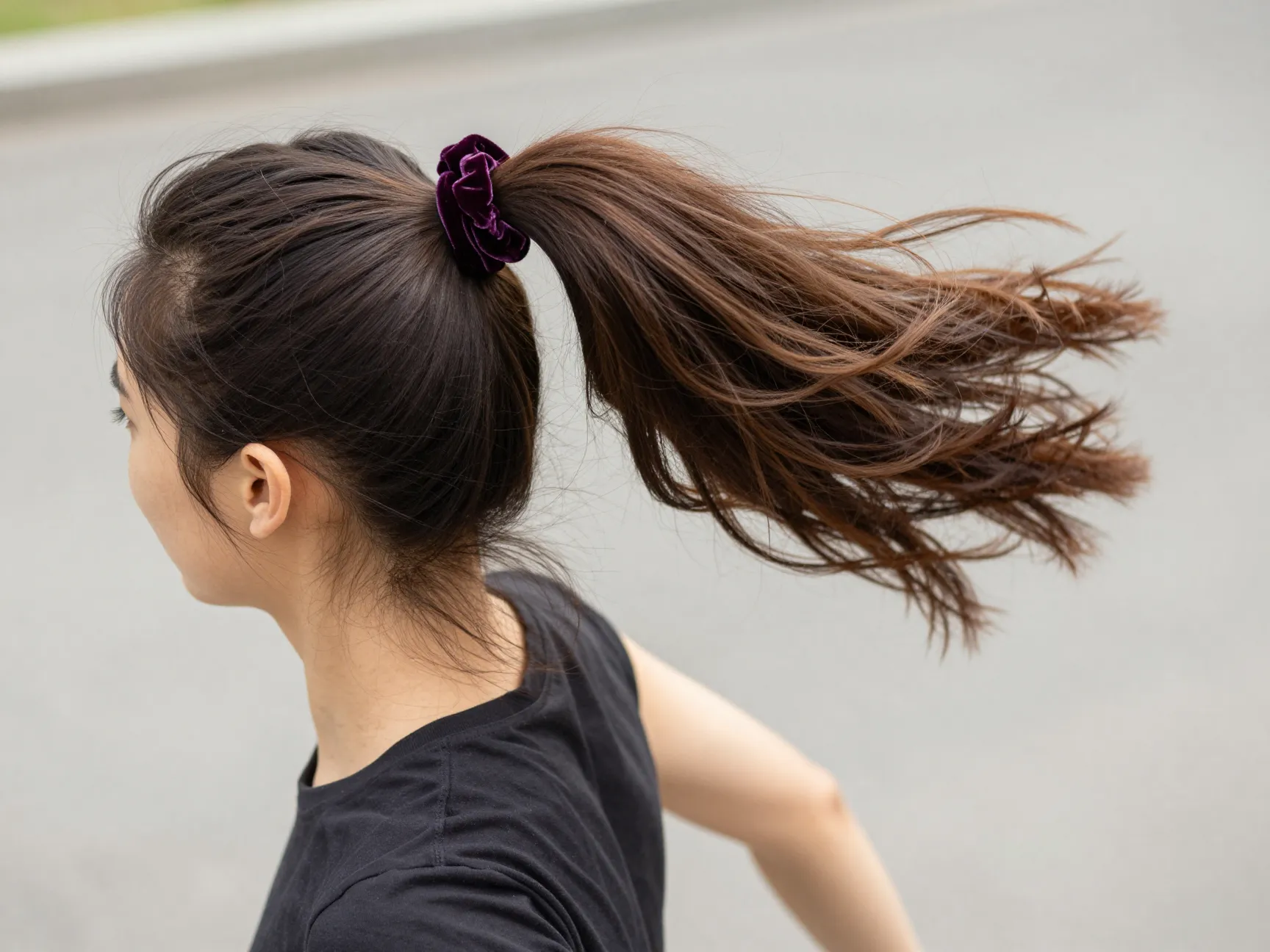 High bouncy ponytail at the crown secured with a velvet scrunchie