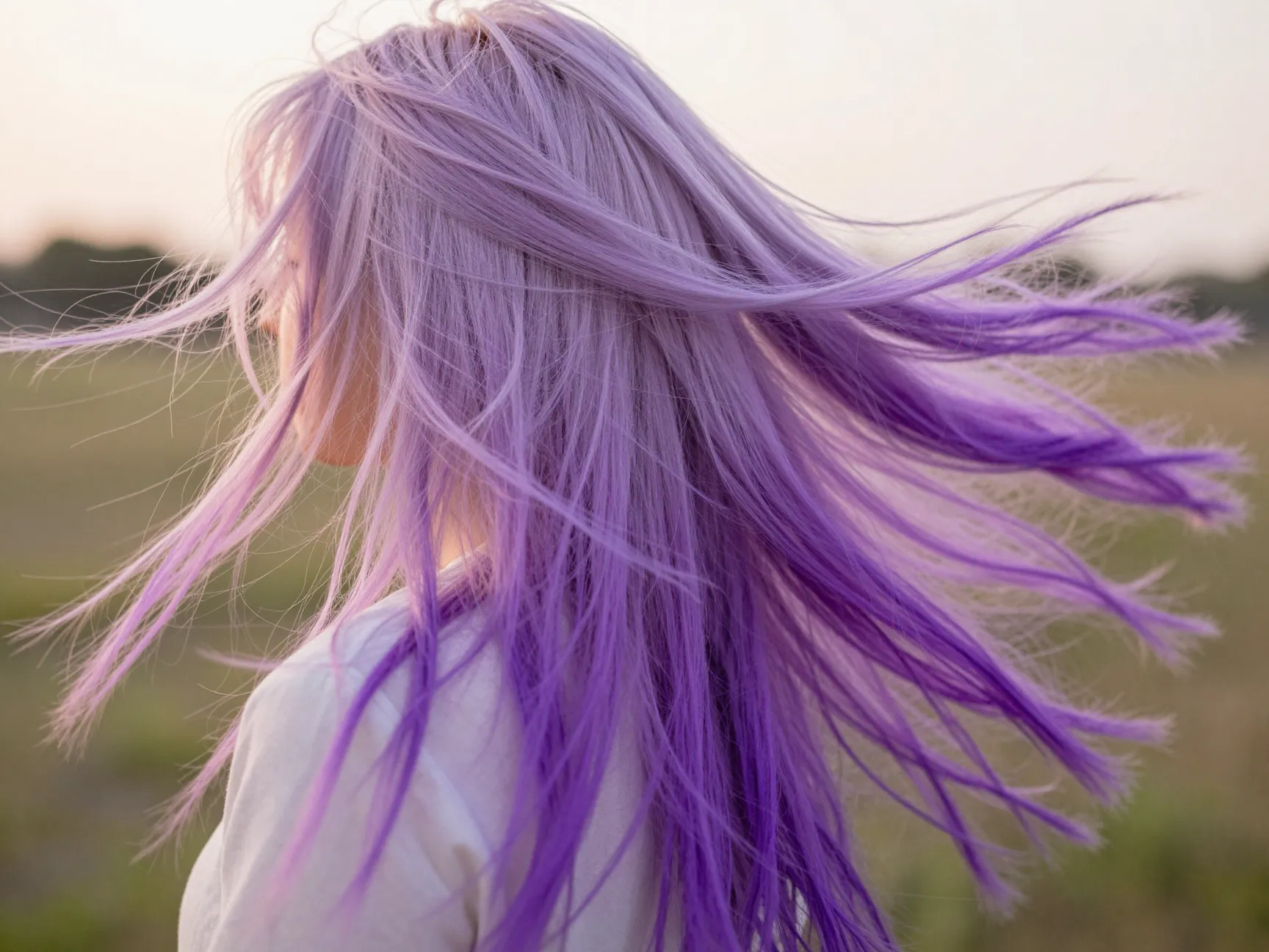 Pastel to vibrant gradient hair with sunset colors blowing in wind