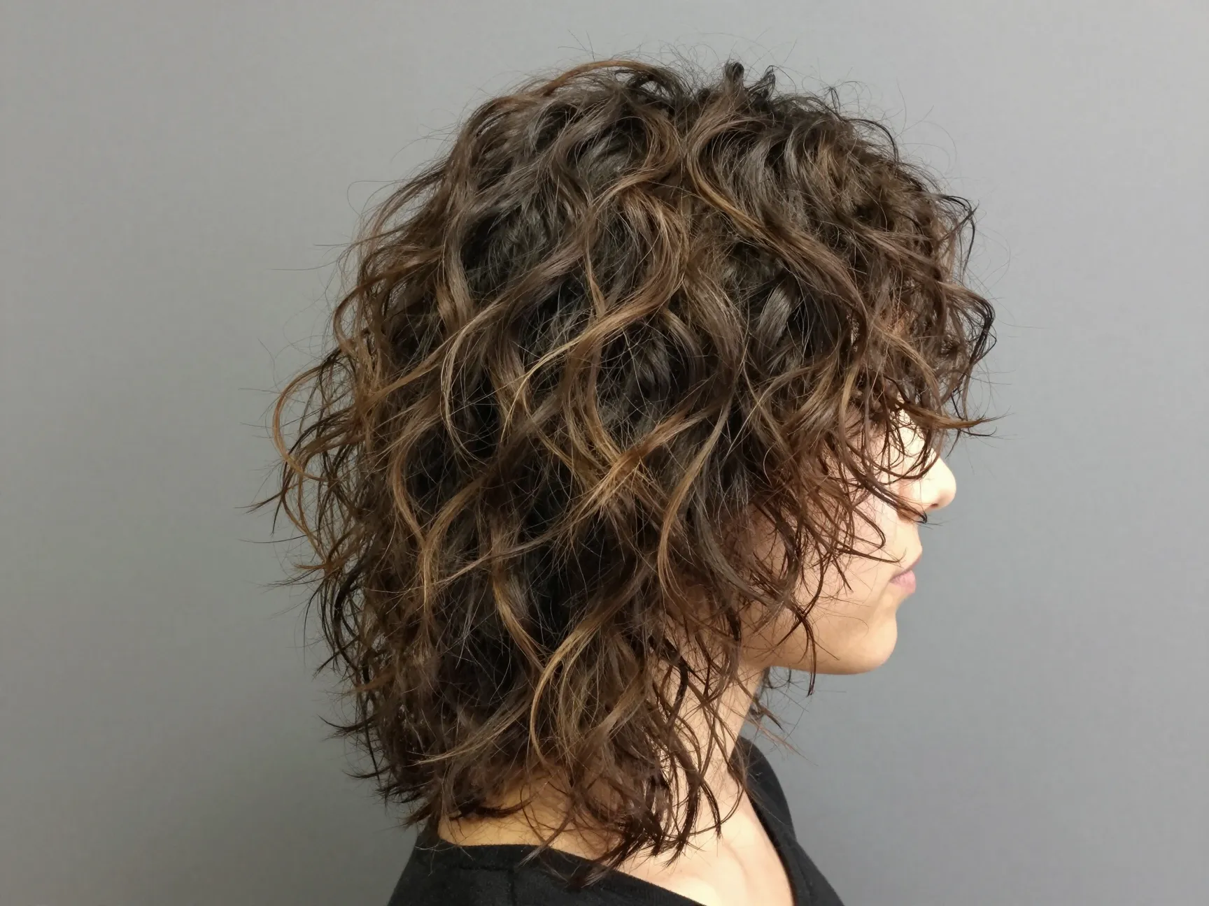 Wolf cut on thick wavy hair with tousled air dried volume