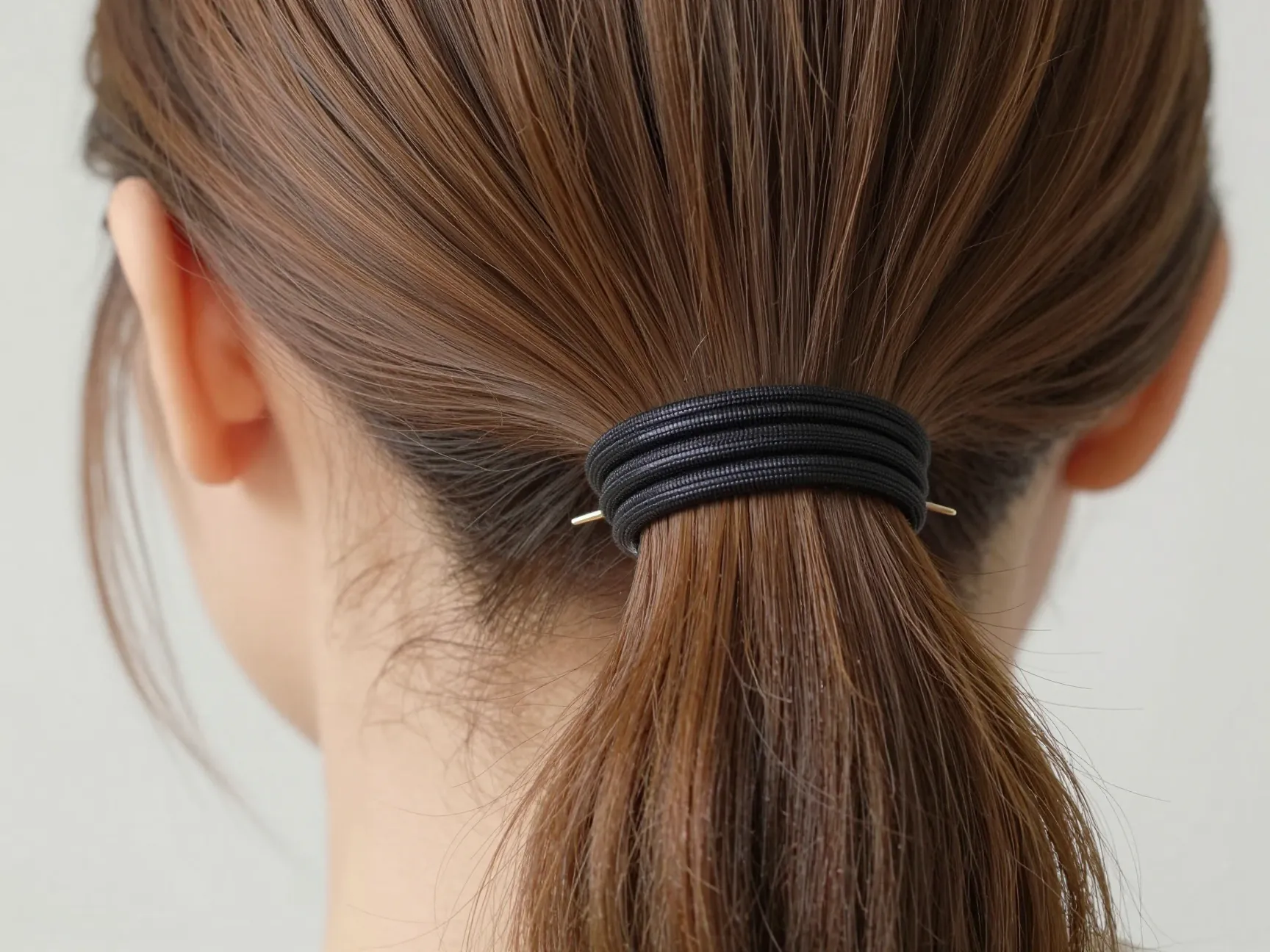 Wrapped elastic ponytail with polished concealed hair tie