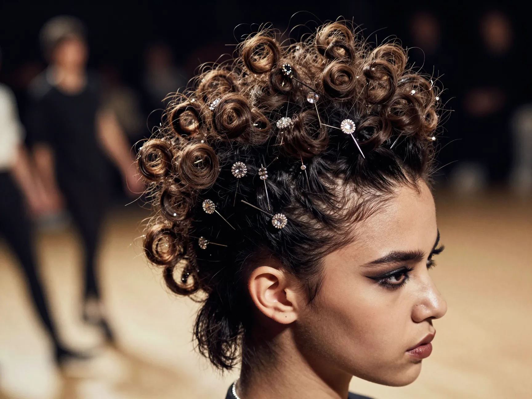 Edgy curly faux hawk updo with bejeweled bobby pins on dance floor