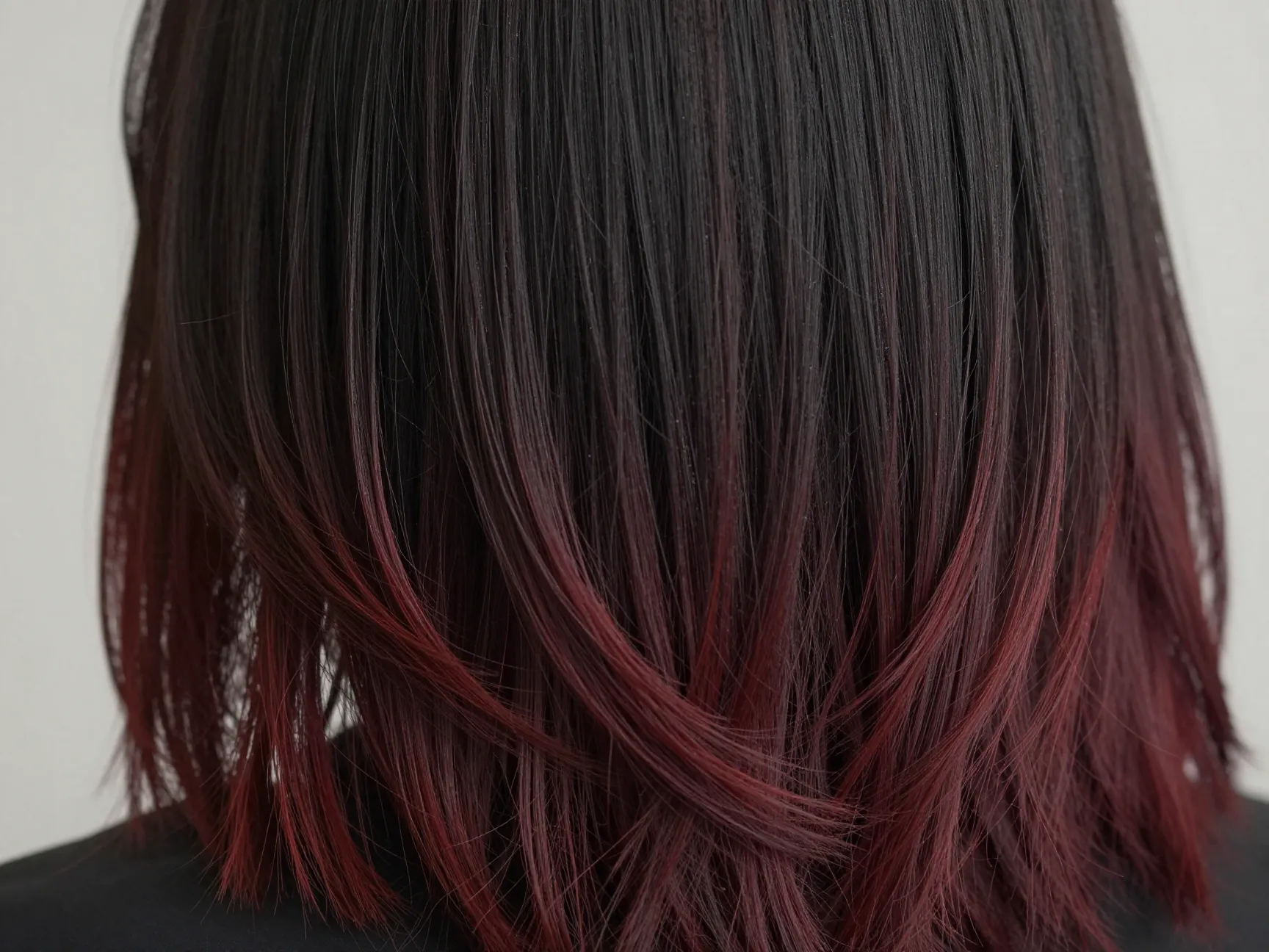 Subtle cherry cola balayage on near black base hair