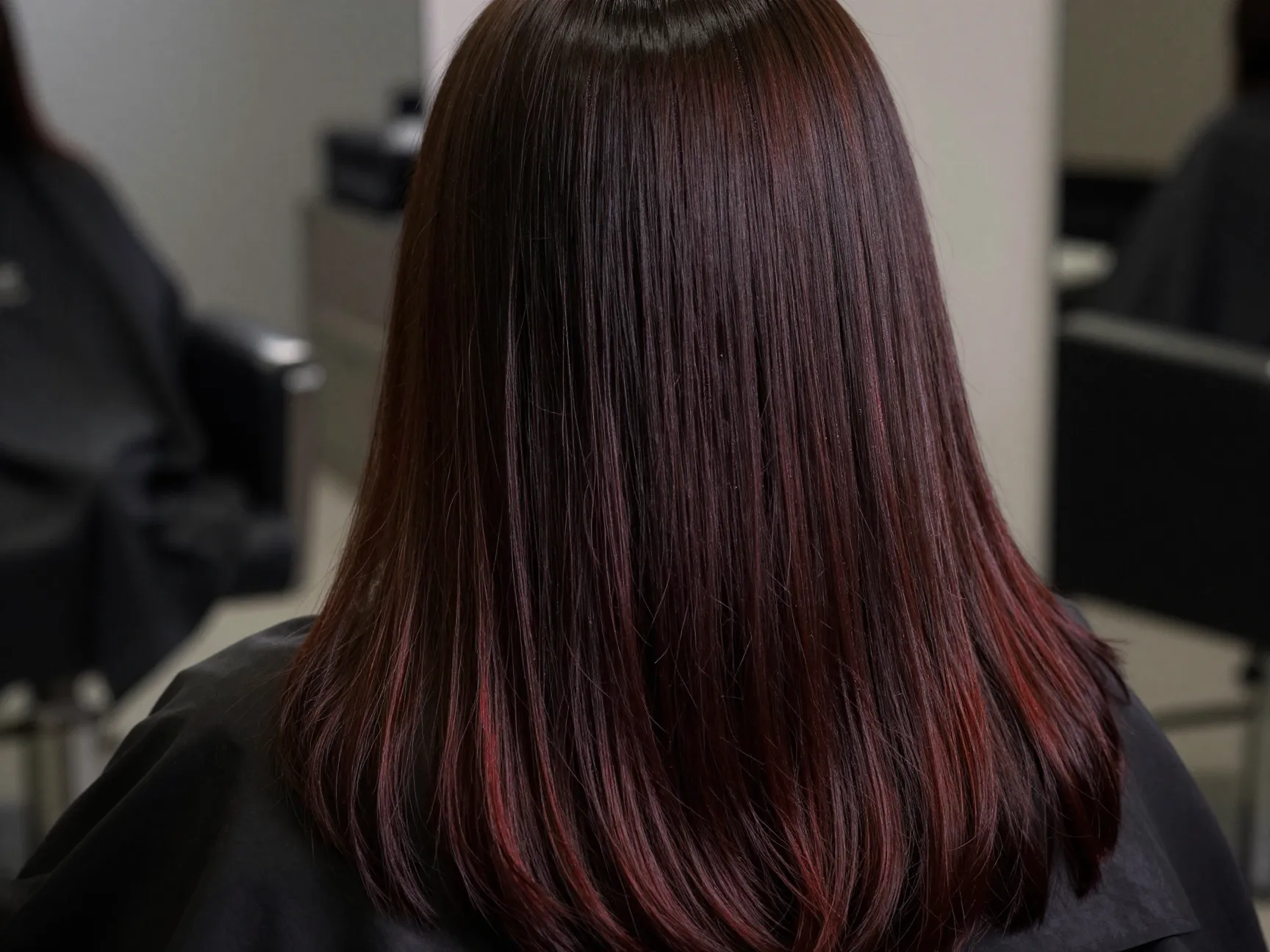 Dark cherry espresso long hair subtly reflects red undertones indoors