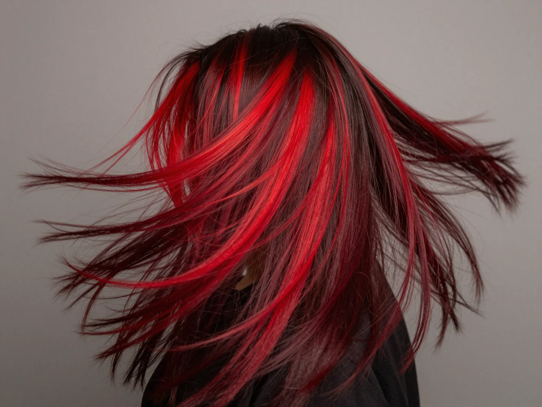 Vivid cherry chocolate long hair with dark base and bold cherry red panels