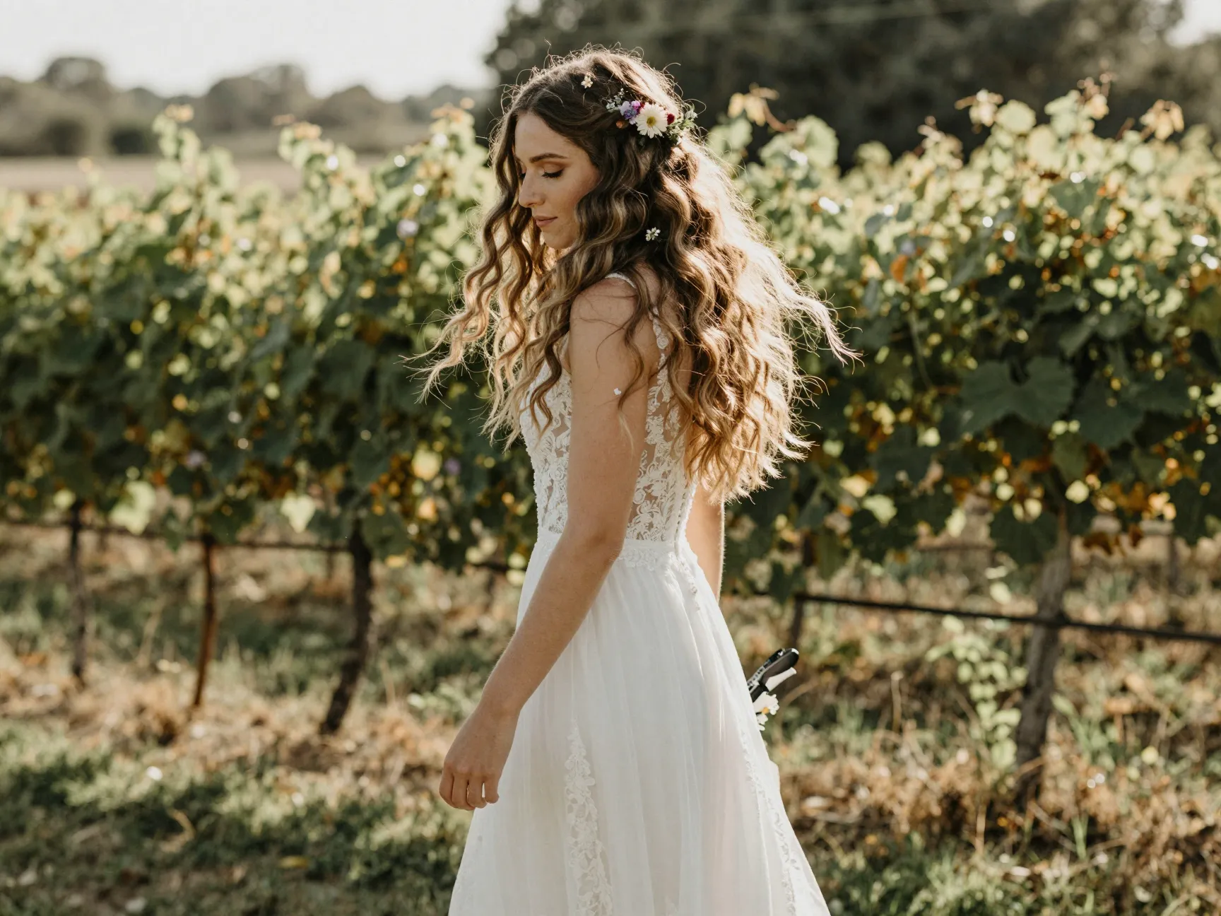 Soft bohemian waves with fresh floral pins at vineyard wedding