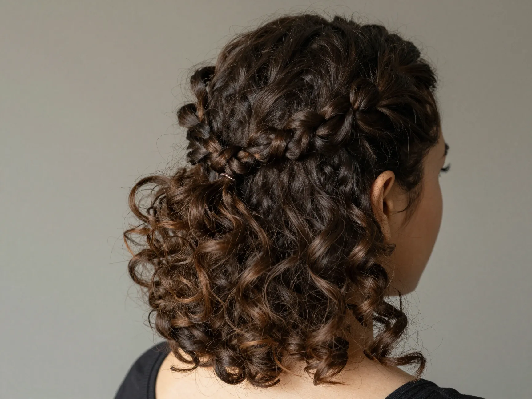 Half up half down twisted sections secure back crown versatile occasion ready