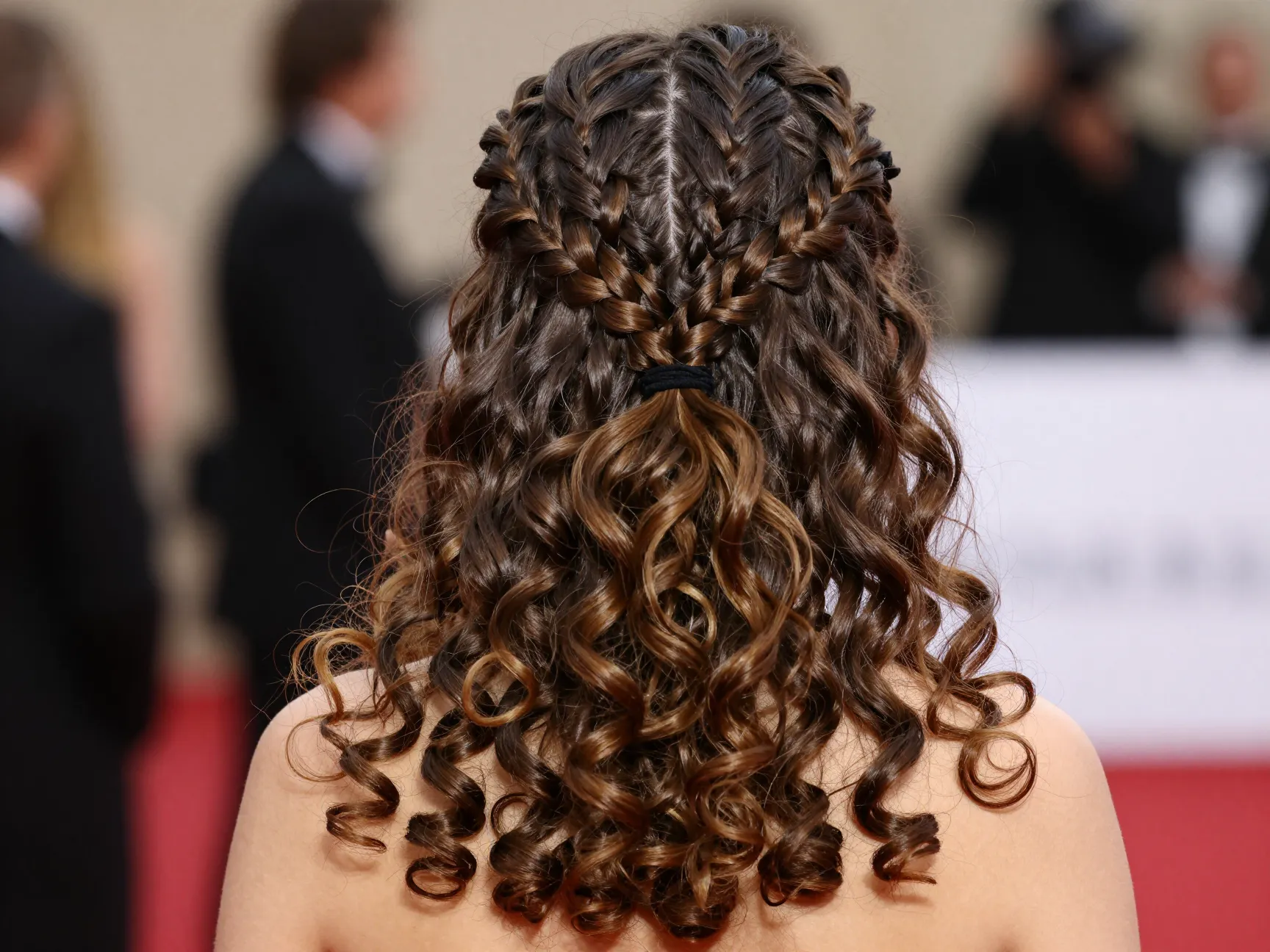 Twisted half up dutch braids pancaked dramatic curls below