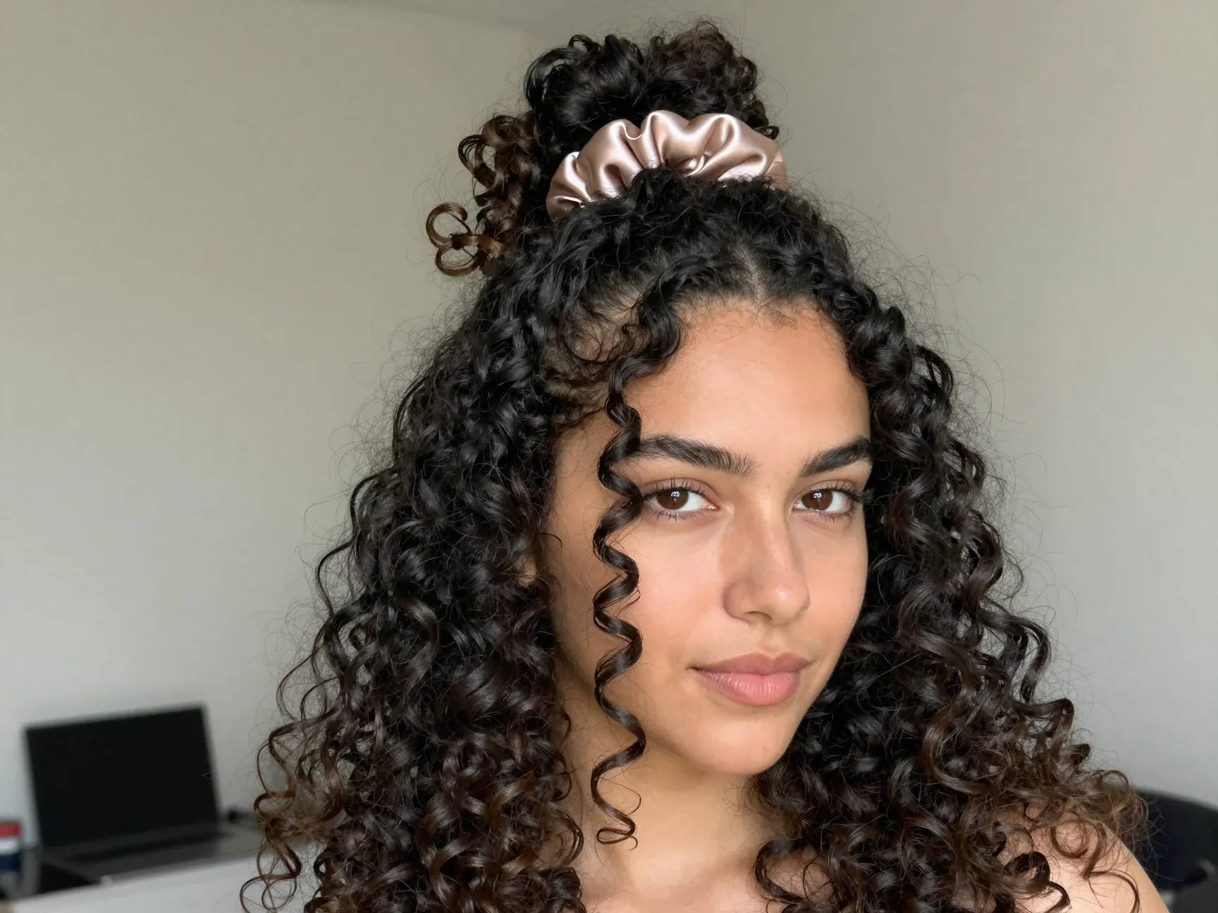 Havana curls half up half down style with satin scrunchie and face framing