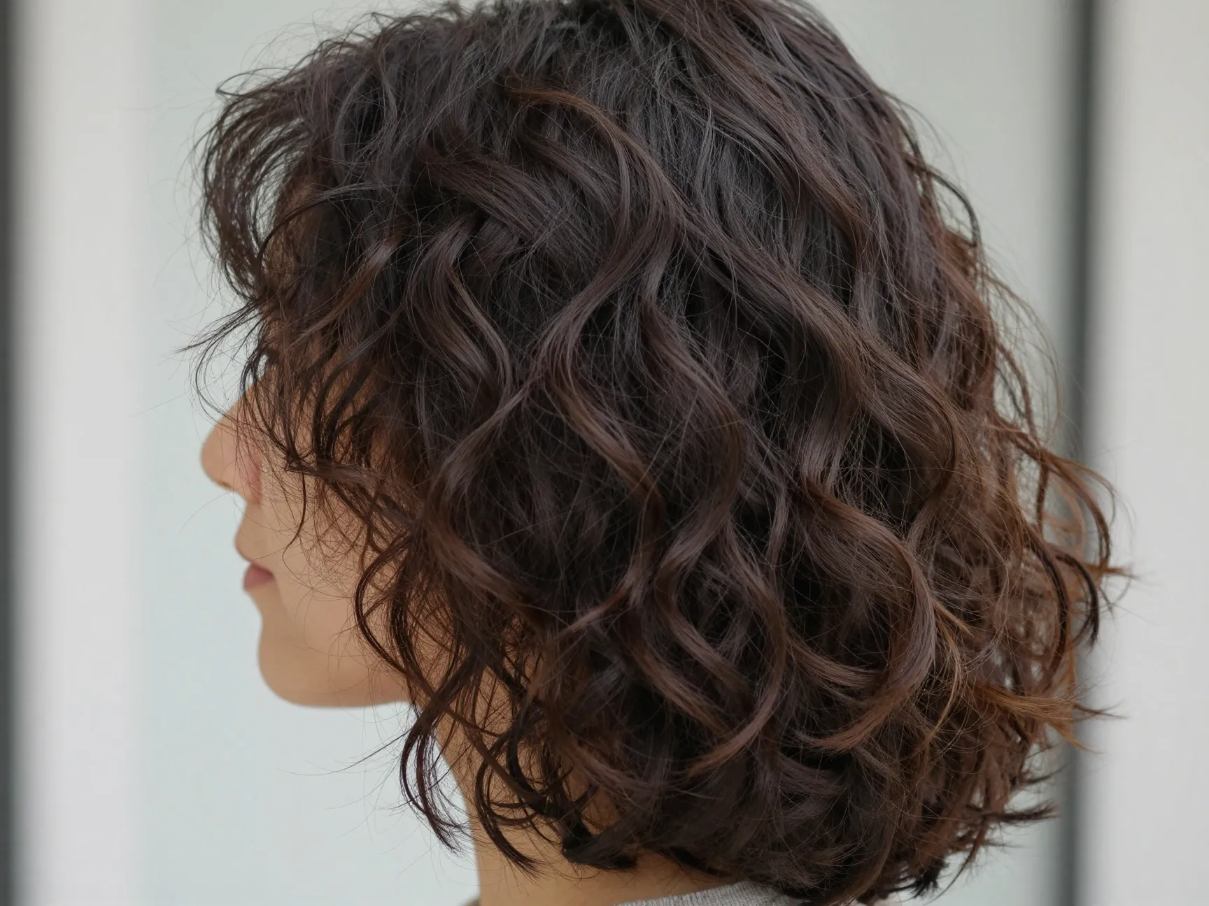 Subtle barely there layers at the ends of medium length curly hair