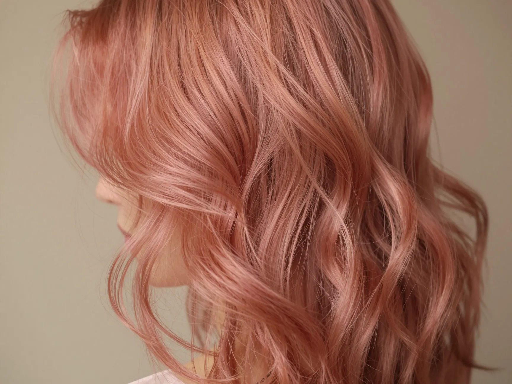 Rose gold dimensional color on loose wavy brunette hair