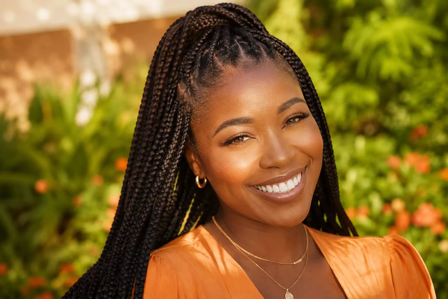 Healthy knotless braids smiling woman outdoor sunlight portrait