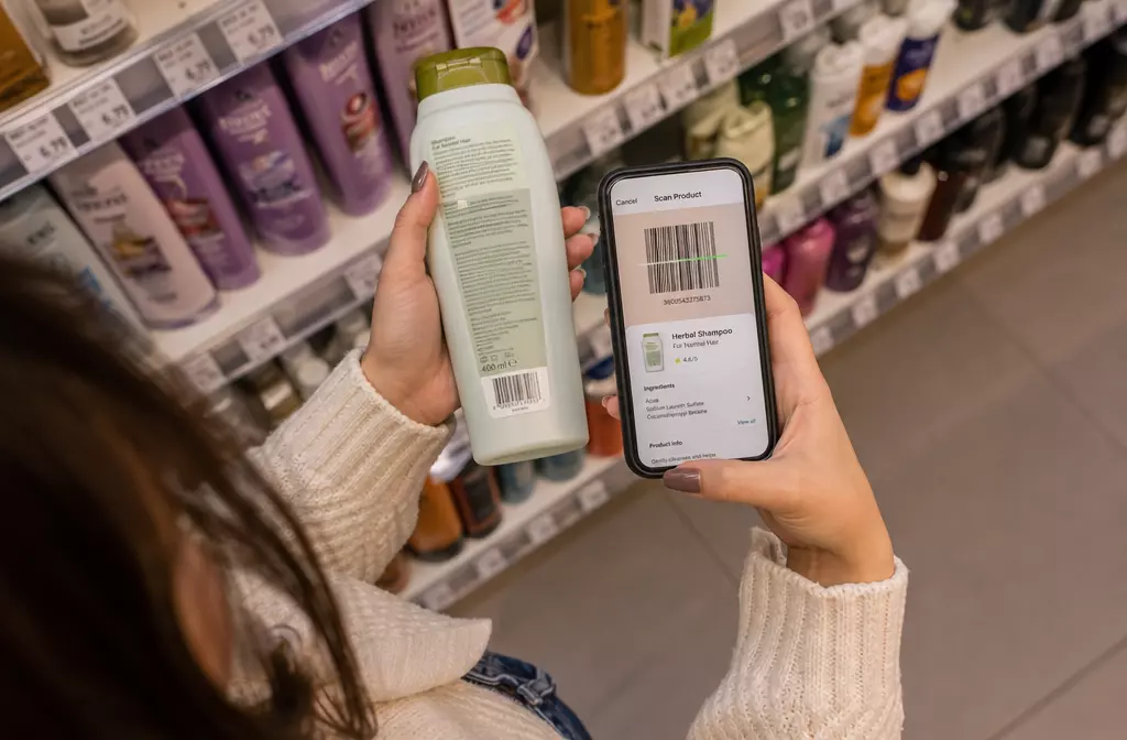 Scanning shampoo barcode with smartphone pharmacy aisle lifestyle