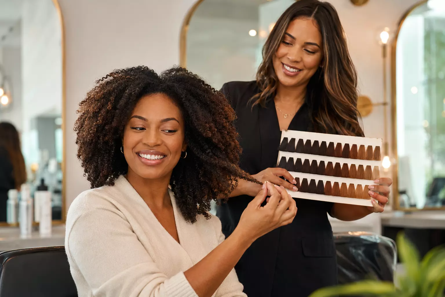 Happy woman salon hairstylist holding hair strand portrait